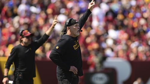 Washington Commmanders head coach Dan Quinn reacts to a play during the first half of an NFL football game against the New York Giants in Landover, Md., Sunday, Sept. 15, 2024. (AP Photo/Steve Ruark)