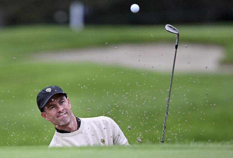 International team member Adam Scott, of Australia, plays a shot from a bunker during a practice round at the Presidents Cup golf tournament at Royal Montreal Golf Club in Montreal, Tuesday, Sept. 24, 2024. (Graham Hughes/The Canadian Press via AP)