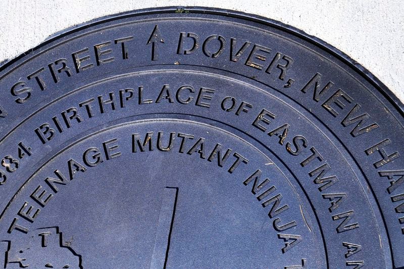 A city manhole cover, noting the Dover, New Hampshire birthplace of the Teenage Mutant Ninja Turtles, is seen at the outside the property, Thursday, Sept. 5, 2024, in Dover. I (AP Photo/Charles Krupa)