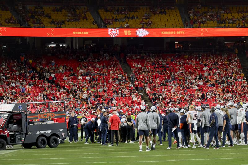 The Chicago Bears gather around teammate Douglas Coleman III as he is treated after being injured during the second half of a preseason NFL football game, Thursday, Aug. 22, 2024 in Kansas City, Mo. (AP Photo/Reed Hoffmann)