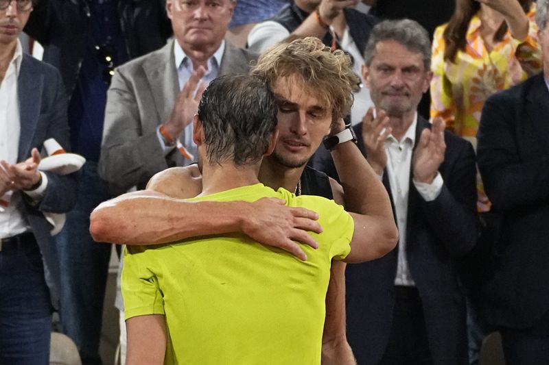 FILE - Germany's Alexander Zverev hugs Spain's Rafael Nadal, after their semifinal match of the French Open tennis tournament at the Roland Garros stadium Friday, June 3, 2022 in Paris. Alexander Zverev stopped playing because of an injury. Rafael Nadal is in the French Open field, after all, and the 14-time champion was set up for a challenging first-round matchup in Thursday’s, May 23, 2024, draw against Alexander Zverev. (AP Photo/Michel Euler, File)
