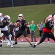 Milton quarterback Luke Nickel (5) looks to pass with protection from Milton offensive lineman during the first half against Buford at Milton High School, Friday, August 16, 2024, in Milton, Ga. (Jason Getz / AJC)
