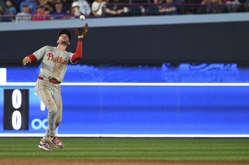 Philadelphia Phillies shortstop Trea Turner catches a pop fly off the bat of Toronto Blue Jays shortstop Ernie Clement in the seventh inning of a baseball game in Toronto on Tuesday Sept. 3, 2024. (Jon Blacker/The Canadian Press via AP)