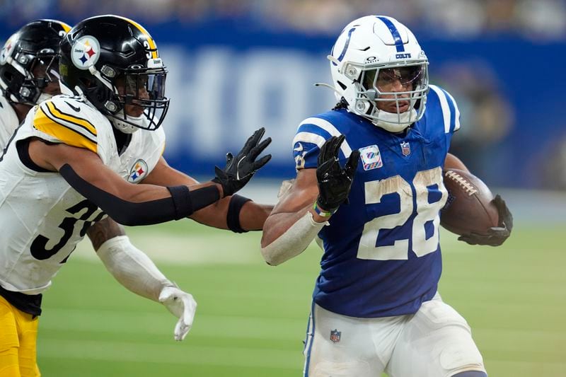 Indianapolis Colts running back Jonathan Taylor (28) carries the ball with Pittsburgh Steelers safety Minkah Fitzpatrick defending during the second half of an NFL football game, Sunday, Sept. 29, 2024, in Indianapolis. (AP Photo/Michael Conroy)