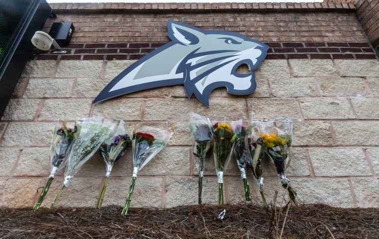 Students and well wishers left flowers at the school’s sign at Apalachee High School in Winder on Thursday, Sept. 5, 2024. A 14-year-old is accused of shooting and killing two fellow students and two teachers and injuring nine others at Apalachee High School on Wednesday. (John Spink/AJC)