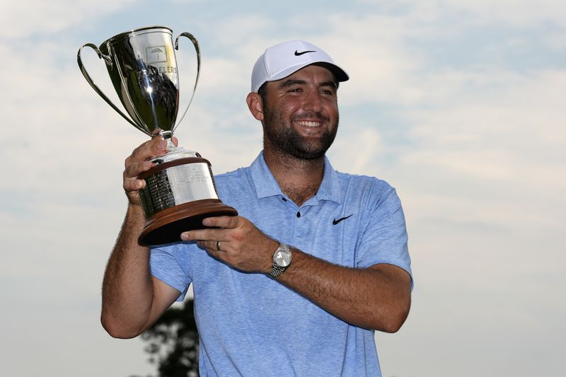 Scottie Scheffler holds up his trophy after winning the Travelers Championship golf tournament at TPC River Highlands, Sunday, June 23, 2024, in Cromwell, Conn. (AP Photo/Seth Wenig)