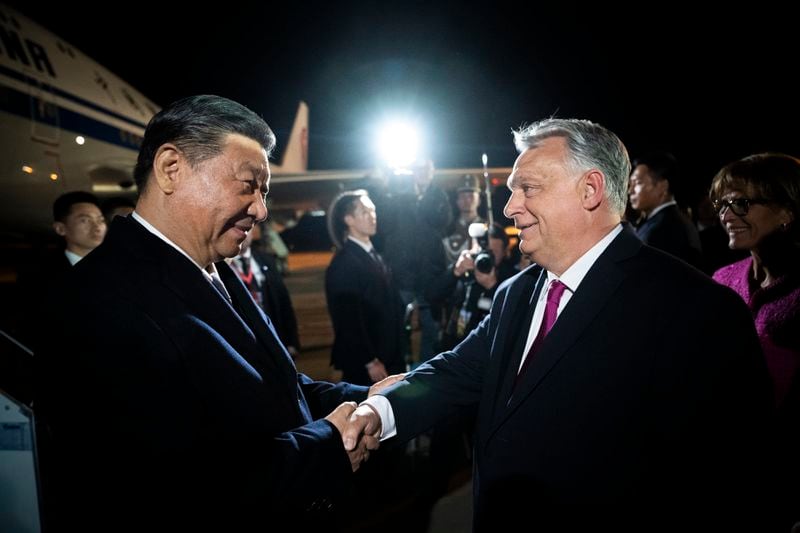 FILE -In this image provided by the Hungarian Prime Minister's Office, Chinese President Xi Jinping, left, shakes hands with Hungarian Prime Minister Viktor Orban as he arrives for a state visit at the Liszt Ferenc International Airport in Budapest, Hungary, Wednesday, May 8, 2024. (Vivien Cher Benko/Hungarian Prime Minister's Office/MTI via AP, File)