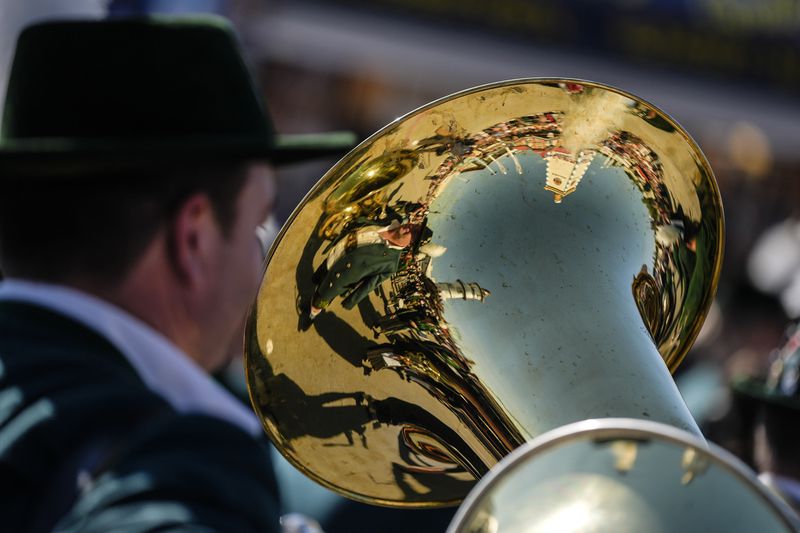 A Bavarian musician mirror in a tuba at the start of the 189th 'Oktoberfest' beer festival in Munich, Germany, Saturday, Sept. 21, 2024. (AP Photo/Matthias Schrader)