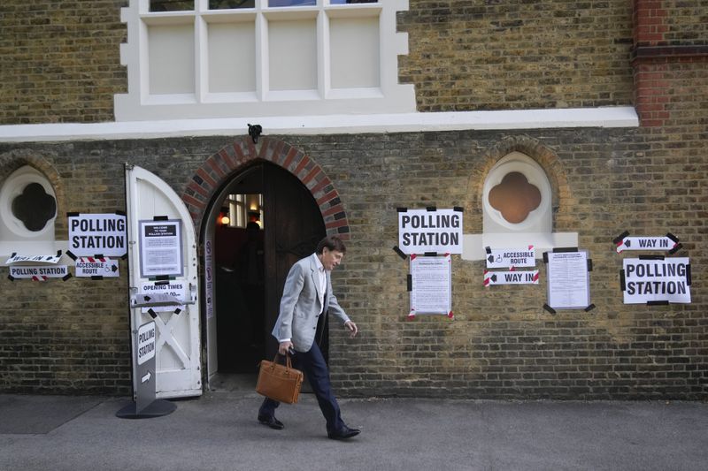 A man leaves a temporary polling station at Wimbledon Village, London, Thursday, July 4, 2024. Voters in the U.K. are casting their ballots in a national election to choose the 650 lawmakers who will sit in Parliament for the next five years. (AP Photo/Mark Baker)