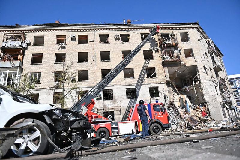In this photo provided by the Ukrainian Emergency Service, rescuers work in a damaged apartment house after it was hit by Russian air bomb killing at least three and injuring 23, in Kharkiv, Ukraine, Saturday, June 22, 2024. (Ukrainian Emergency Service via AP)