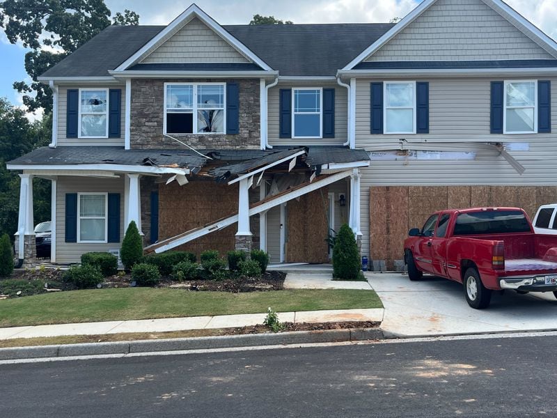 The Hiram-area home remained boarded up on Monday following the fatal shooting of Paulding County Deputy Brandon Cunningham