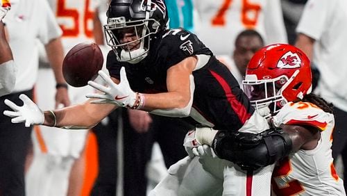 Atlanta Falcons wide receiver Drake London (5) loses the ball but recovers against Kansas City Chiefs linebacker Nick Bolton (32) during the second half of an NFL football game, Sunday, Sept. 22, 2024, in Atlanta. (AP Photo/Brynn Anderson)