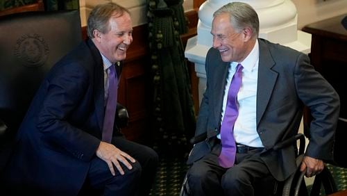 FILE - Texas Attorney General Ken Paxton, left, and Gov. Greg Abbott talk during on the first day of the 88th Texas Legislative Session in Austin, Texas, Jan. 10, 2023. Abbott and Paxton are looking to settle political scores within their own party in the Tuesday, May 27, 2024, primary runoff elections. Abbott is focusing on GOP members who helped defeat his 2023 education plan. Paxton has targeted more than 30 incumbents who voted to impeach him last year on corruption charges. (AP Photo/Eric Gay, File)