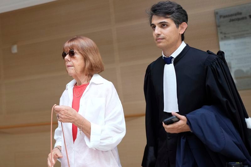 Gisele Pelicot, left, arrives in the Avignon court house, in Avignon, southern France, Thursday, Sept. 5, 2024. A woman allegedly drugged by her ex-husband so that she could be raped by other men while she laid unconscious, is expected to testify before a panel of French judges. (AP Photo/Lewis Joly)