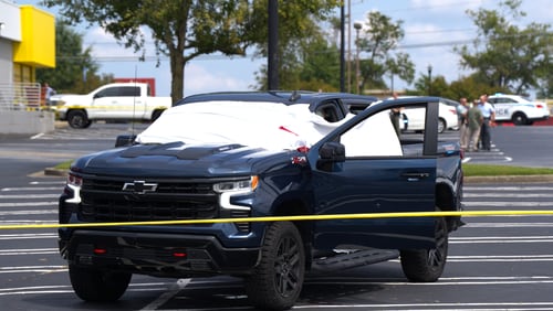 The victim was found dead in his truck at the Mall Corners shopping center in Duluth.