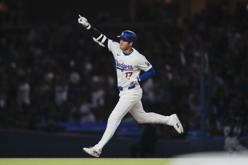 Los Angeles Dodgers designated hitter Shohei Ohtani (17) runs the bases after hitting a home run during the first inning of a baseball game against the Chicago Cubs in Los Angeles, Wednesday, Sept. 11, 2024. (AP Photo/Ashley Landis)