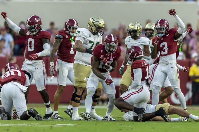 Alabama linebacker Deontae Lawson (0), linebacker Justin Jefferson (15) and defensive back Keon Sabb (3) react to a stop against South Florida during the first half of an NCAA college football game, Saturday, Sept. 7, 2024, in Tuscaloosa, Ala. (AP Photo/Vasha Hunt)