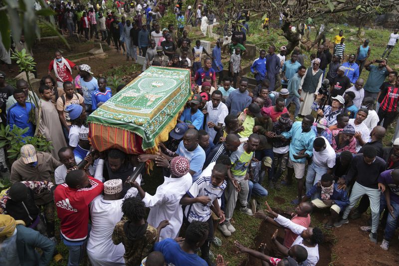 Relatives carry the body of 19-year-old Ibrahim Kamau for burial, at the Kariakor cemetery in Nairobi, Kenya Friday, June 28, 2024. Kamau was shot during a protest on Tuesday against the government proposed tax bill. Protesters stormed parliament on Tuesday and drew police fire in chaos that left several people dead. (AP Photo/Brian Inganga)