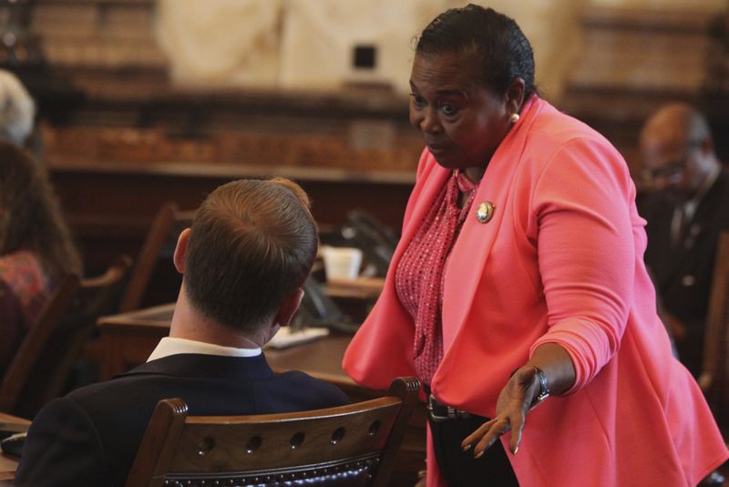 Kansas state Sen. Oletha Faust-Goudeau, right, D-Wichita, confers with Sen. Ethan Corson, left, D-Prairie Village, during a Senate debate on a proposal aimed at luring the Super Bowl champion Kansas City Chiefs from Missouri, Tuesday, June 18, 2024, at the Statehouse in Topeka, Kansas. The measure would allow Kansas to issue bonds to help the Chiefs and professional baseball's Kansas City Royals new stadiums in Kansas. (AP Photo/John Hanna)