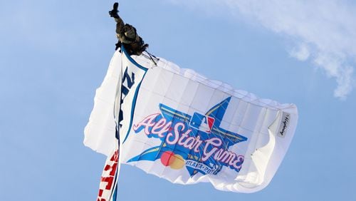 A parachute flies approaching Truist Park during the unveiling celebrations of the 2025 All-Star Game logo on Monday, July 22, 2024, in Atlanta.

(Miguel Martinez/ AJC)