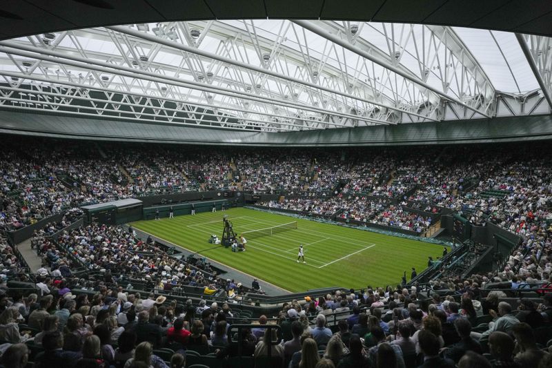 Coco Gauff of the United States plays Anca Todoni of Romania under the roof on court one on day three at the Wimbledon tennis championships in London, Wednesday, July 3, 2024. (AP Photo/Mosa'ab Elshamy)