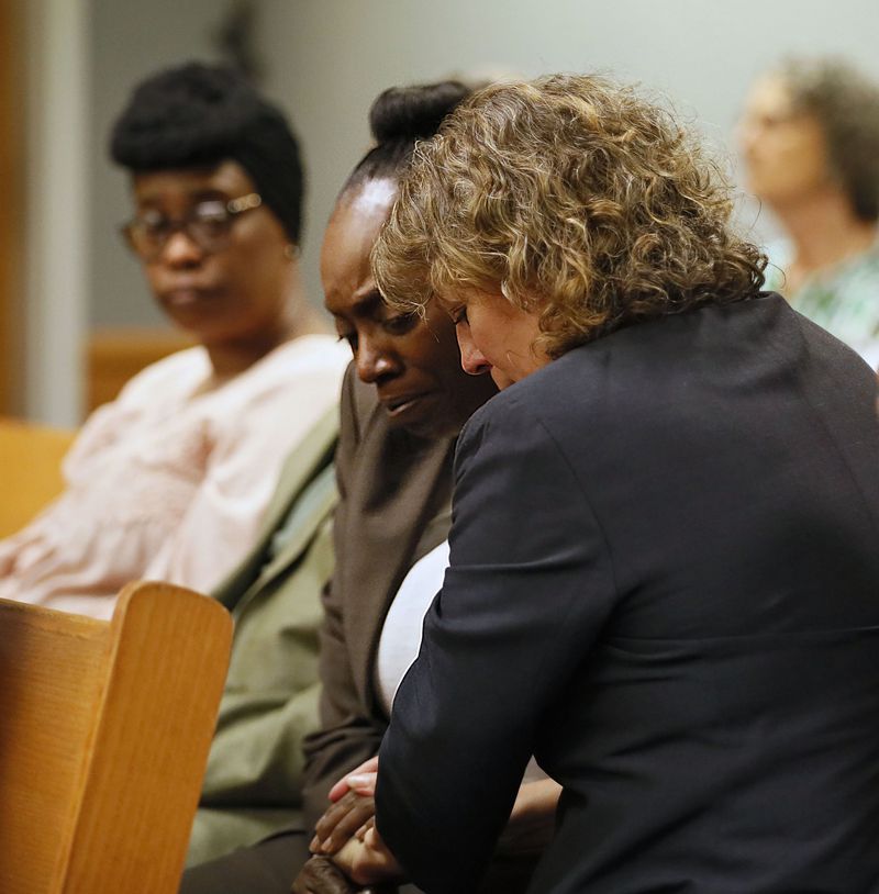 April 24, 2019 - Lawrenceville -  Lisa Neal (right), who was Emani Moss' elementary school teacher, gives Robin Moss, Emani's grandmother, a hug after Neal testified during Day One of the Tiffany Moss death penalty trial. Tiffany Moss is accused of starving her  stepdaughter Emani, and then trying to burn the corpse.     