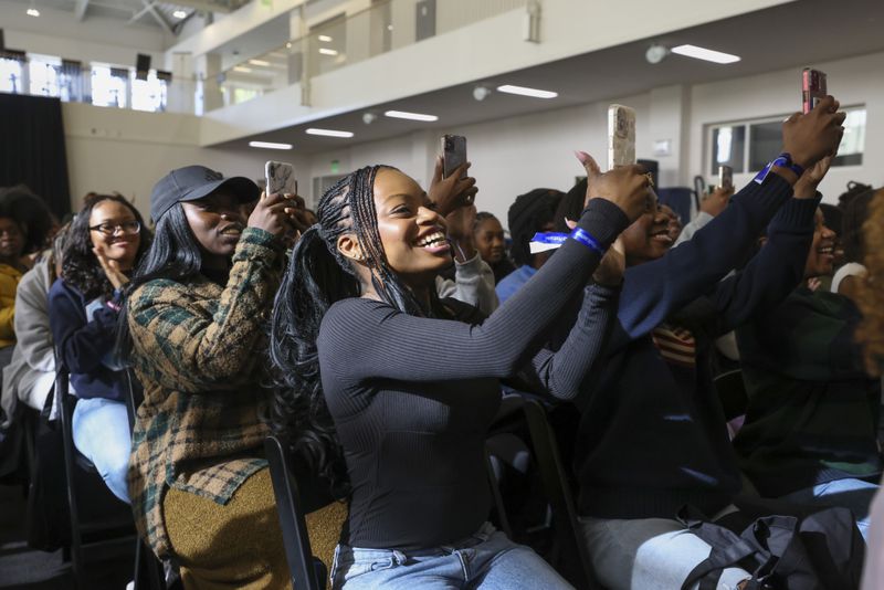 Spelman students take photos as influencers Rickey Thompson and Denzel Dion take the stage during Spelman Creator Day at the Wellness Center Gymnasium at Spelman College, Monday, March 20, 2023, in Atlanta. Creator Day is an audio event including influencers Rickey Thompson, Denzel Dion, and Wunmi Bello. Spelman is the first HBCU to partner with Spotify for its NextGen program. (Jason Getz / Jason.Getz@ajc.com)
