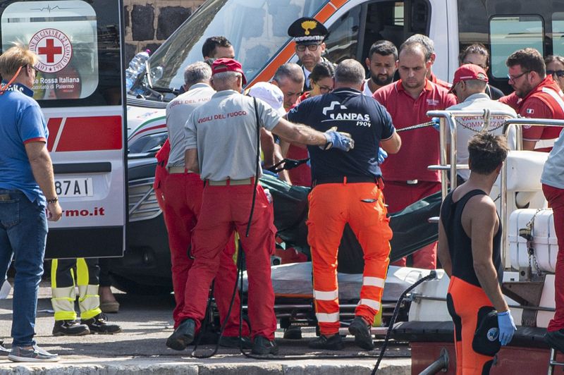 Rescuers recoup the body of one of the victims of the UK flag vessel Bayesan that sunk early Monday, Aug. 19, 2024, while at anchor off the Sicilian village of Porticello near Palermo, in southern Italy. (AP Photo/Lucio Ganci)