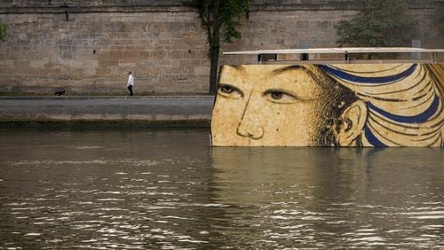 FILE - Reproductions of artworks decorate the banks of the River Seine at the 2024 Summer Olympics, Tuesday, July 30, 2024, in Paris, France. Concerns over water quality in the Seine River resurfaced at the Paralympic Games on Thursday when organizers changed the schedule for para triathlon races. (AP Photo/ Dar Yasin, File)