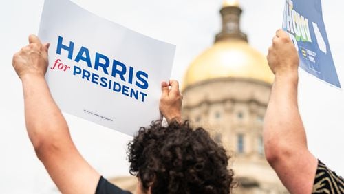 Young Democrats of Georgia member Royce Mann of Atlanta holds a sign in support of Vice President Kamala Harris’ presidential campaign at a July 24 news conference at Liberty Plaza near the Georgia State Capitol in Atlanta. (Seeger Gray/The Atlanta Journal-Constitution)