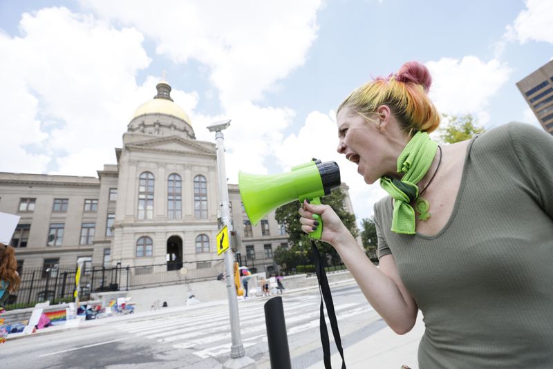 Arguments over Georgia’s new abortion law ban began Monday in Fulton County Superior Court. Pictured is a demonstrator outside the  the Georgia State Capitol, where in July people gathered to protest the reversal of Roe. v. Wade by the U.S. Supreme Court. (Miguel Martinez/AJC)