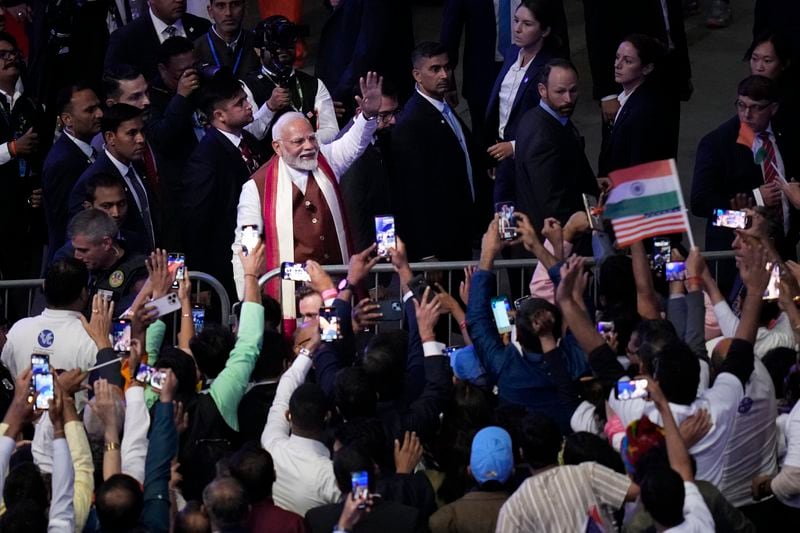 Narendra Modi, Prime Minister of India, top left, waves to the crowd after speaking at an event in Uniondale, N.Y., Sunday, Sept. 22, 2024. (AP Photo/Seth Wenig)