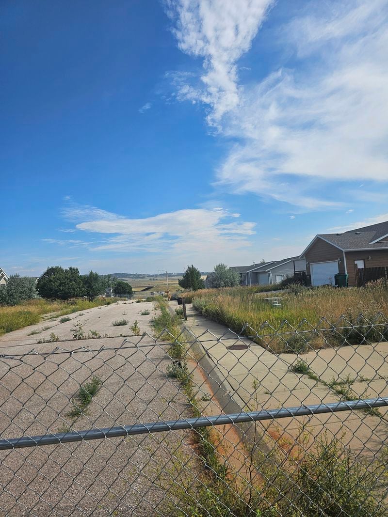 This photo taken April 27, 2022, by Tonya Junker shows a sinkhole in the Hideaway Hills neighborhood near Rapid City, S.D. (Tonya Junker via AP)