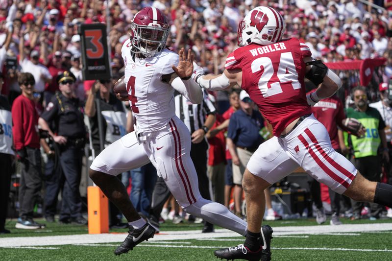 Alabama's Jalen Milroe (4) runs past Wisconsin's Hunter Wohler (24) for a touchdown during the second half of an NCAA college football game Saturday, Sept. 14, 2024, in Madison, Wis. (AP Photo/Morry Gash)