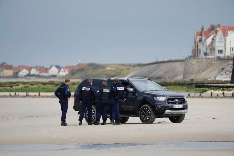 Police guard on the Wimereux beach, France, Wednesday, Sept. 4, 2024. Another boat carrying several dozen people is making another attempt to cross the English Channel from northern France just a day after 12 migrants died. (AP Photo/Nicolas Garriga)