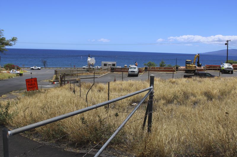 The ocean can be seen from the entrance to a dump site in Lahaina, Hawaii on Thursday, July 18, 2024. (AP Photo/Jennifer Sinco Kelleher)