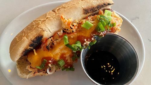 TKO sells the Volcano Dog, a fried beef hot dog topped with spicy imitation-crab salad, which is torched and drizzled with spicy mayo, eel sauce and Sriracha. Wendell Brock for The AJC