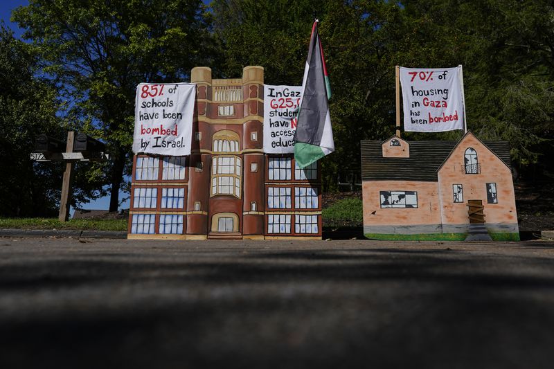 A display describing the bombing of Gaza is seen near the driveway of Ohio Democratic Rep. Greg Landsman's Cincinnati residence, Monday, Oct. 7, 2024. (AP Photo/Carolyn Kaster)