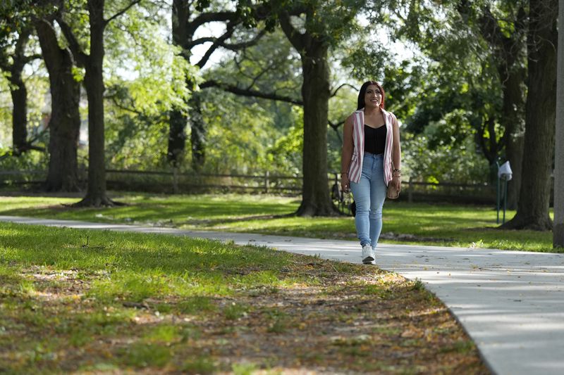 Julieth Luna Garcia, a transgender woman from El Salvador, takes a walk at Horner Park in Chicago, Monday, Sept. 30, 2024. (AP Photo/Nam Y. Huh)