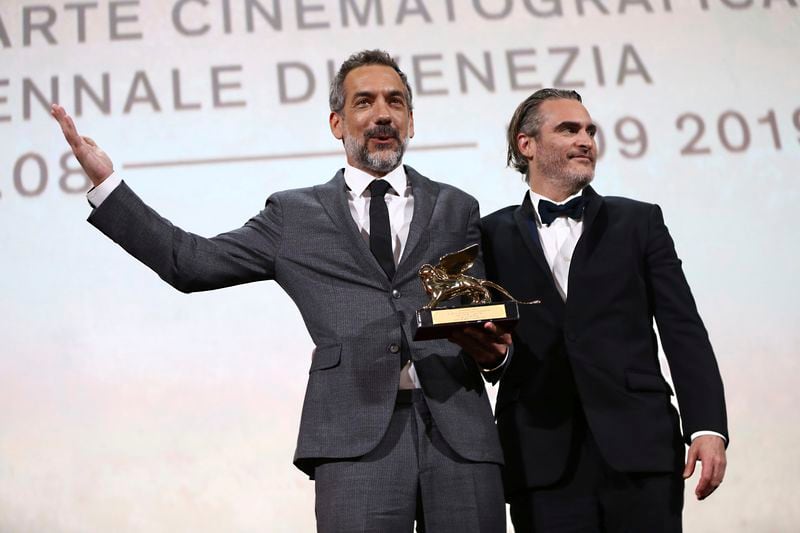 FILE - Director Todd Phillips, left, holds the Golden Lion for Best Film for "Joker," joined by lead actor Joaquin Phoenix at the closing ceremony of the 76th edition of the Venice Film Festival, Venice, Italy on Sept. 7, 2019. (Photo by Joel C Ryan/Invision/AP, File)