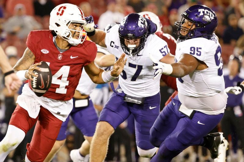 Stanford quarterback Ashton Daniels (14) scrambles and completes a pass against TCU in Stanford, Calif., Friday, Aug. 30, 2024. (Santiago Mejia/San Francisco Chronicle via AP)