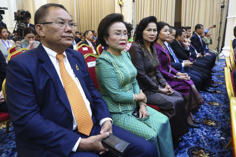 In this photo released by Agence Kampuchea Press (AKP), Cambodian businesspeople, Ly Yong Phat, the president of the L.Y.P. Group, left, and Choeung Sopheap, second from left, attend a ceremony for the return of artifacts at Peace Palace in Phnom Penh, Cambodia, Thursday, Aug. 22, 2024. (AKP via AP)