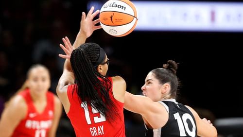 Atlanta Dream guard Allisha Gray (15) is fouled by Las Vegas Aces guard Kelsey Plum (10) during the first half of an WNBA basketball game Friday, Aug. 30, 2024 in Las Vegas. (Steve Marcus/Las Vegas Sun via AP)