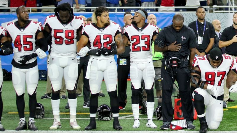 Members of the Atlanta Falcons during the playing of the national anthem prior to the start of the game against the Detroit Lions Sept. 24, 2017, at Ford Field in Detroit.