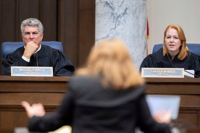 Georgia Supreme Court Chief Justice Michael Boggs and Justice Sarah Warren listen to oral arguments from attorney Elizabeth Young, representing the Secretary of State, at the Supreme Court in Atlanta on Tuesday, Sept. 24, 2024. (Arvin Temkar/Atlanta Journal-Constitution via AP)