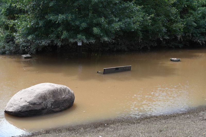 A park bench and trash can sit submerged near the boat ramp at Amerson River Park after the effects of Hurricane Helene on Monday, Sept. 30, 2024, in Macon, Georgia. The park is closed until further notice as many of its trails have flooded from the increased rainfall of Hurricane Helene last week. (Photo Courtesy of Katie Tucker/The Telegraph)