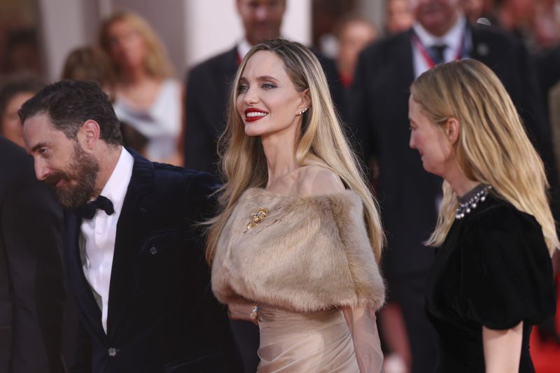 Director Pablo Larrain, from left, Angelina Jolie, and Alba Rohrwacher pose for photographers upon arrival for the premiere of the film 'Maria' during the 81st edition of the Venice Film Festival in Venice, Italy, on Thursday, Aug. 29, 2024. (Photo by Vianney Le Caer/Invision/AP)