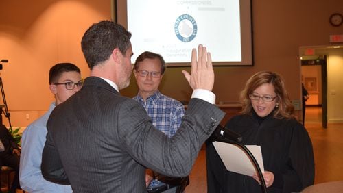 Henry County Probate Court Judge Kelley Powell swears in Henry County Commissioner Dee Anglyn during Monday inauguration ceremony.