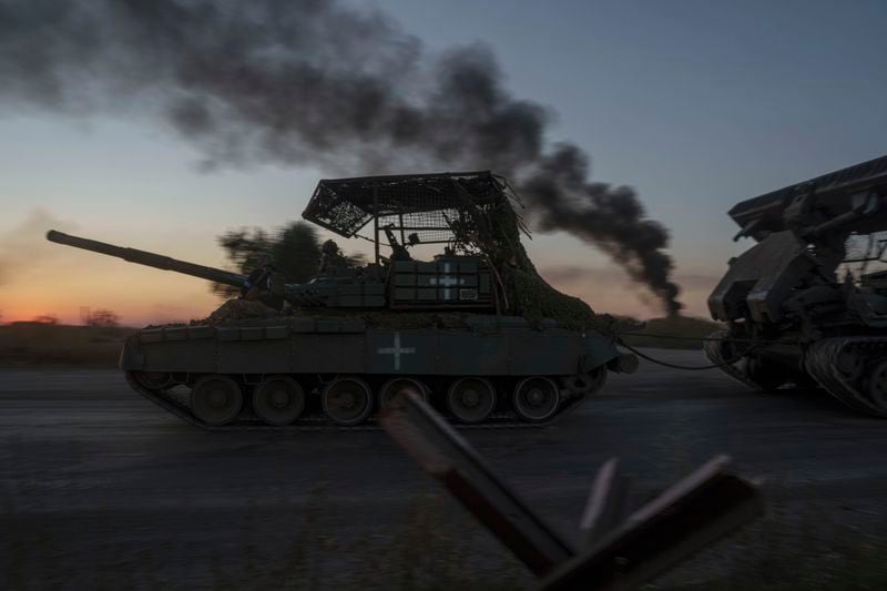 FILE - Ukrainian servicemen ride atop a tank after returning from Russia near the Russian-Ukrainian border in Sumy region, Ukraine, on Saturday, Aug. 17, 2024. (AP Photo/Evgeniy Maloletka, File)