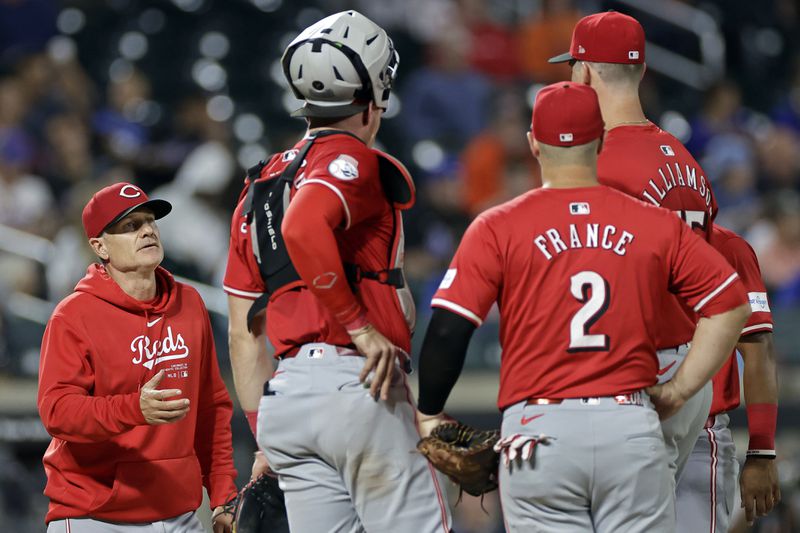 Cincinnati Reds manager David Bell reaches for the ball from pitcher Brandon Williamson during a pitching change in the sixth inning of a baseball game against the New York Mets, Friday, Sept. 6, 2024, in New York. (AP Photo/Adam Hunger)